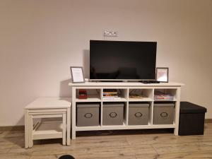 a white entertainment center with a flat screen tv on it at Apartament Górska Panorama in Szklarska Poręba