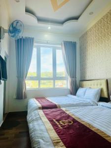 Postel nebo postele na pokoji v ubytování Bình Dương Đà Lạt Hotel
