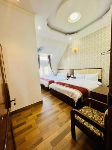 Postel nebo postele na pokoji v ubytování Bình Dương Đà Lạt Hotel