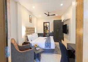 a bedroom with a bed and a living room at The Verda De Miranda Resort Morjim North Goa in Morjim