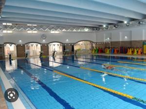 a large indoor swimming pool with people in it at DREAM HOUSE in Naples