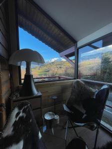 a room with two chairs and a large window at CHALET MONT BLANC in Combloux