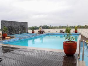 a swimming pool on top of a building at Flora Airport Hotel and Convention Centre Kochi in Nedumbassery
