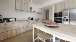 a kitchen with a wooden counter top and a refrigerator at Villa Higueras in Santa Eularia des Riu