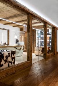 a room with wooden walls and wooden flooring and a mirror at Hotel Tyrol in Selva di Val Gardena