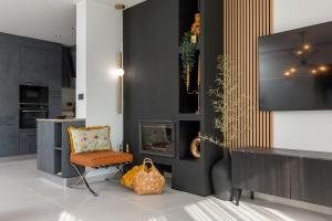 een woonkamer met een stoel en een televisie bij Villa M Premantura in Premantura