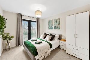 a white bedroom with a bed and a large window at Boutique Beautiful Leeds Gem - Sleeps 2 in Leeds