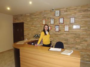 a woman standing behind a counter in a room at Likhvinskie Vody Resort in Rozhdestveno