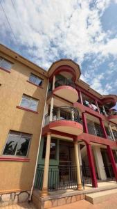 a large building with balconies on the side of it at Cozy Apartment within Acacia mall area limits, Unlimited WIFI, Netflix, Free Parking in Kampala