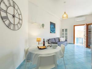 a dining room and living room with a table and chairs at Holiday Home La Notte Stellata in San Vito lo Capo