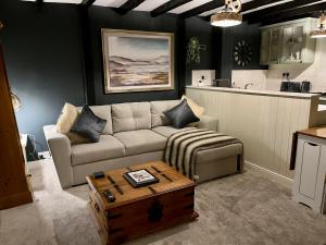 a living room with a couch and a coffee table at Granny Vera's @ Marigold Cottage in Bedale