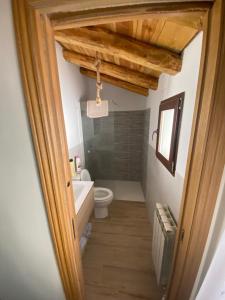 a bathroom with a toilet and a sink at Casa Juan in Gea de Albarracín