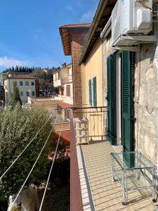 einen Balkon mit einem Glastisch auf einem Haus in der Unterkunft CasaTosca in Chianciano Terme