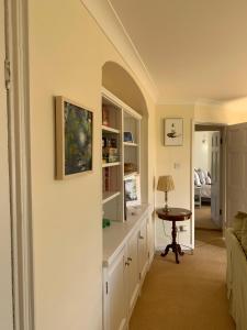 a living room with a desk and a table at Ideally located Luxury Country Escape-The Lookout-with private garden dog friendly and private hot tub in Honiton