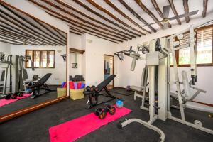 a fitness room with treadmills and exercise machines at Zanzibar Queen Hotel in Matemwe