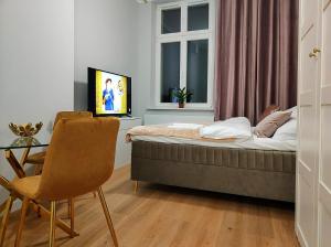 Televízia a/alebo spoločenská miestnosť v ubytovaní Hugo Star Apartments