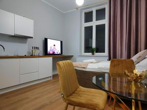 Televízia a/alebo spoločenská miestnosť v ubytovaní Hugo Star Apartments