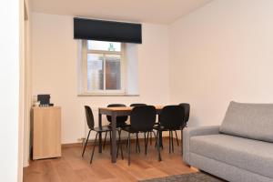 a living room with a table and chairs and a couch at PM CityAPART Lend in Graz