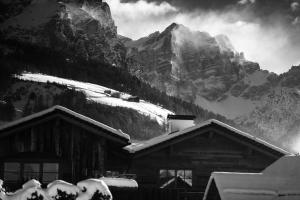 a black and white photo of a cabin in the mountains at Sportony Mountain Lodges in La Villa