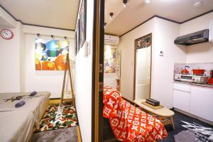 a small room with a bed and a kitchen at TOKYO ICHIBAN ASAKUSA in Tokyo