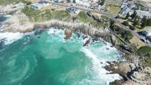 an aerial view of the ocean and a beach at Boutique Ocean Views Guesthouse in Hermanus