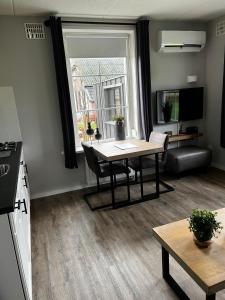 a living room with a table and a window at Veldzicht in Klarenbeek