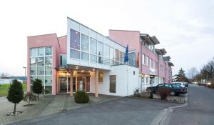 a building with a car parked in front of it at Hotel an der Waldstraße in Groß-Zimmern
