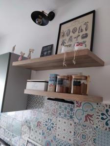 a bedroom with two wooden shelves above a bed at B&B A casa di Carla in Castelsaraceno