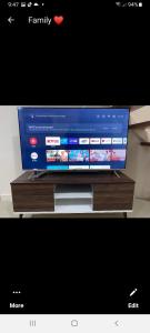 a flat screen tv sitting on top of a wooden stand at VICTORIA DE MAKATI Two (2) Bedroom Up and Down Condo in Manila +10 photos