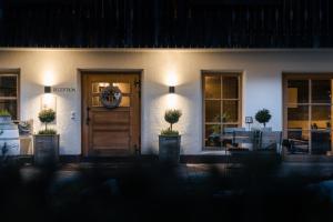 a front door of a house at night at Sportony Mountain Lodges in La Villa