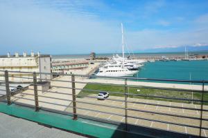 a car parked in a marina with boats in the water at L'incanto Di Boccadarno in Marina di Pisa