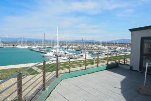 a balcony with a view of a marina with boats at L'incanto Di Boccadarno in Marina di Pisa