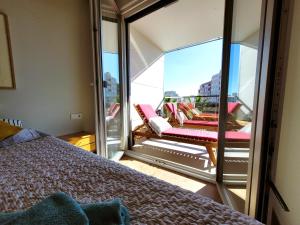 um quarto com uma varanda com uma cama e uma janela em Apartement Verano El Campello - 2 Bedrooms - Piscina - Garaje em El Campello