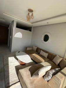 a living room with a couch and a table at Shiny appartment in Prestigia in Rabat