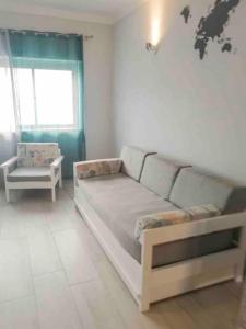 a living room with a bed and a window at Beautiful and cozy flat close to beach and center in Lagos