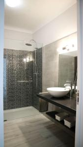 a bathroom with a sink and a shower at Beautiful and cozy flat close to beach and center in Lagos