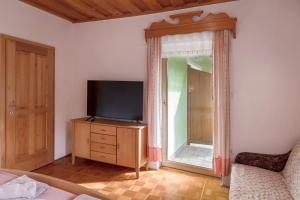 a living room with a television and a window at Gostišče Marin Miler in Prevalje