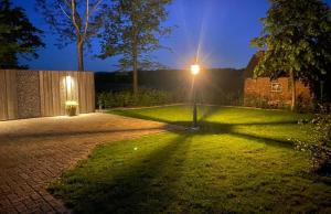 Klarenbeek的住宿－Veldzicht，夜晚在院子中间的街道灯