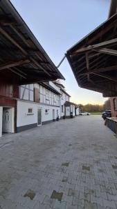 an empty parking lot with a building in the background at Großzügige Wohnung auf dem Hof Historischen Mühle in Holzhausen