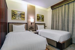 Postel nebo postele na pokoji v ubytování Al Ertiqaa Hotel