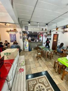 a room with people sitting at tables in a restaurant at Ratanawong Place 404 in Bangkok
