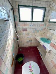 a bathroom with a toilet and a sink at Ratanawong Place 404 in Bangkok