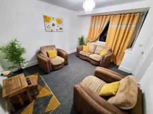 a living room with couches and chairs and a table at nc23, setup for your most amazing & relaxed stay + Free Parking + Free Fast WiFi in Farnley
