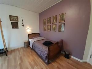 a bedroom with a bed and pictures on the wall at Topagergaard in Bredsten