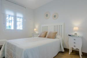 Ένα ή περισσότερα κρεβάτια σε δωμάτιο στο Laja Bermeja, piscina y primera línea de La Barrosa +30 φωτογραφίες