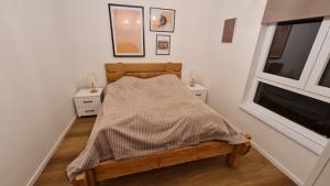 a bedroom with a bed and two night stands at Wood Apartmani - Vila Zimska idila Jahorina in Jahorina