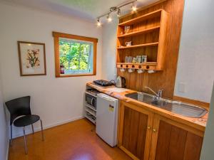 a kitchen with a sink and a dishwasher at Bay Cottage - Takaka Holiday Unit in Takaka