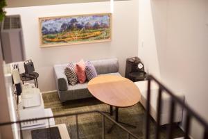 a living room with a couch and a table at Flower Base Ume House in Fukuoka