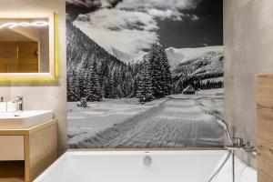 a bathroom with a picture of a snow covered forest at APARTAMENT No 2 MOUNTAIN VIEV Sauna Priv z ogrodem okolice Zakopane Czorsztyn Kluszkowce in Kluszkowce