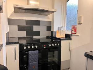 a kitchen with a black stove top oven at 44 Trevithick view in Saint Erth